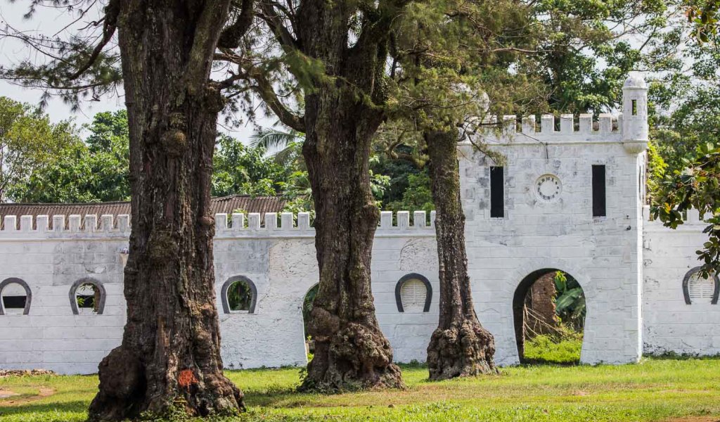 Ruins of an old stone building surrounded by lush greenery