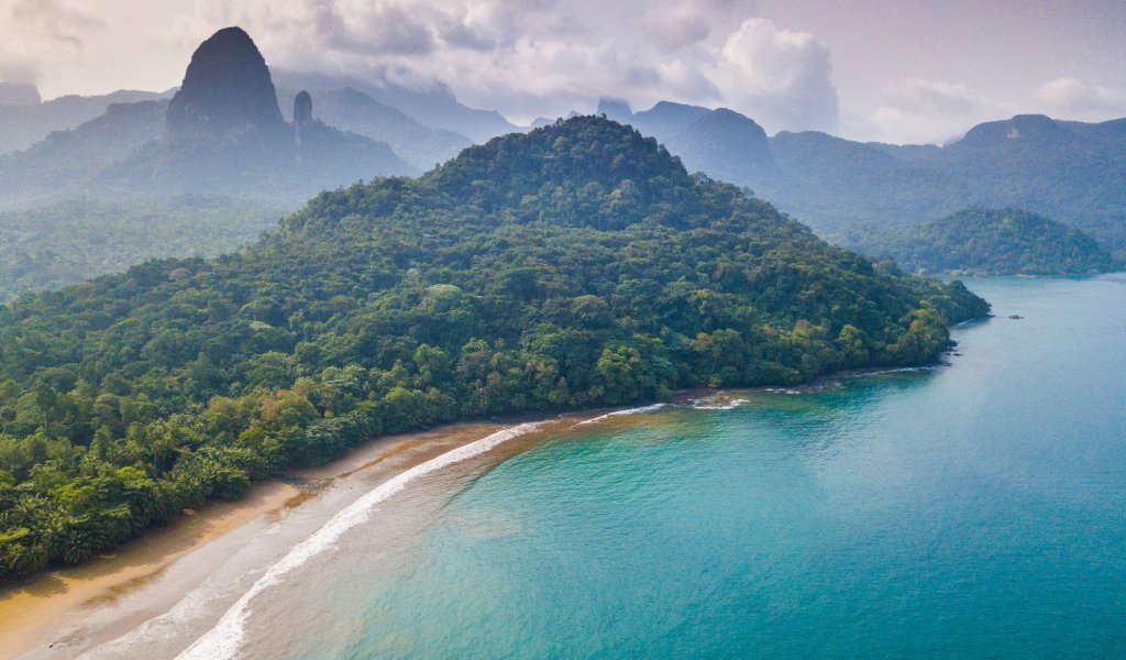 Aerial view of a secluded beach with lush forest on São Tomé Island