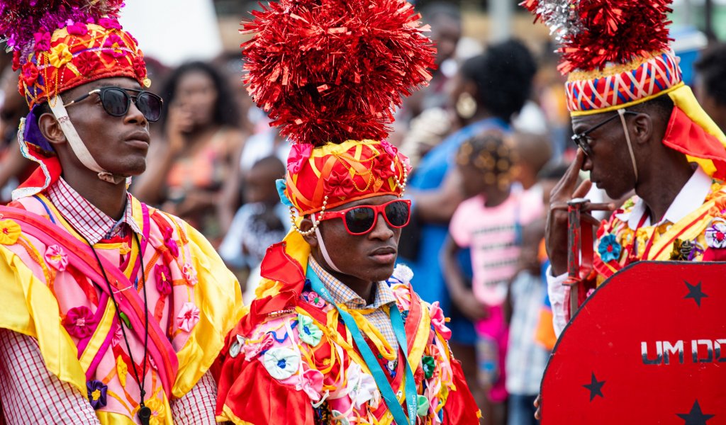 Three men in traditional costumes during a holiday on Príncipe Island