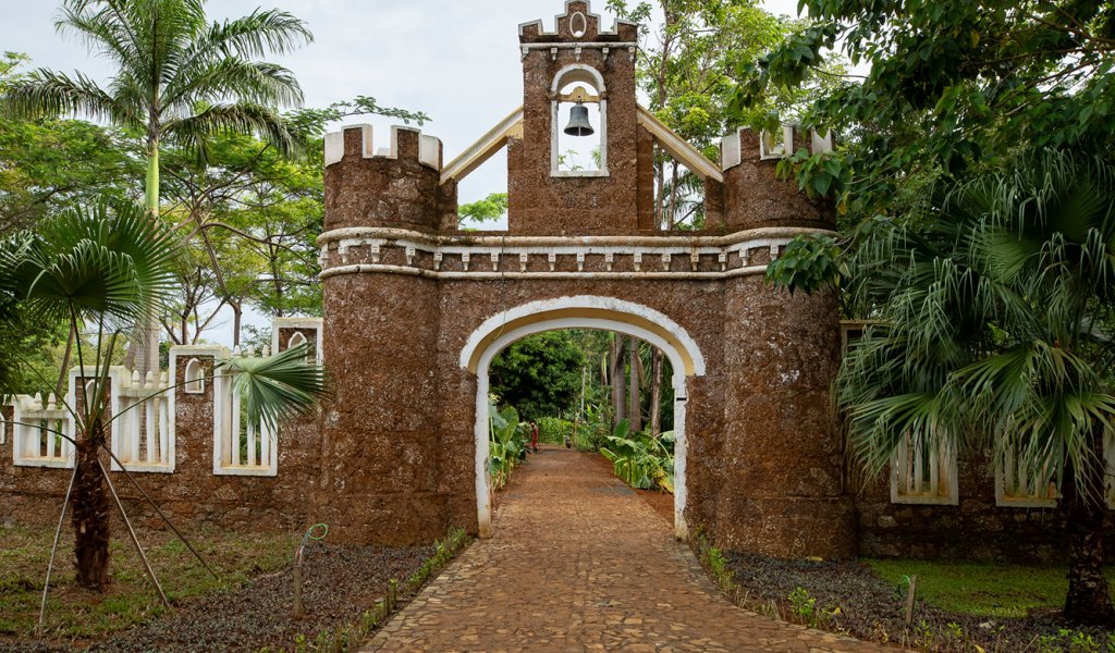 Historic fortified stone gateway with a bell tower at the entrance to Belo Monte on Príncipe Island