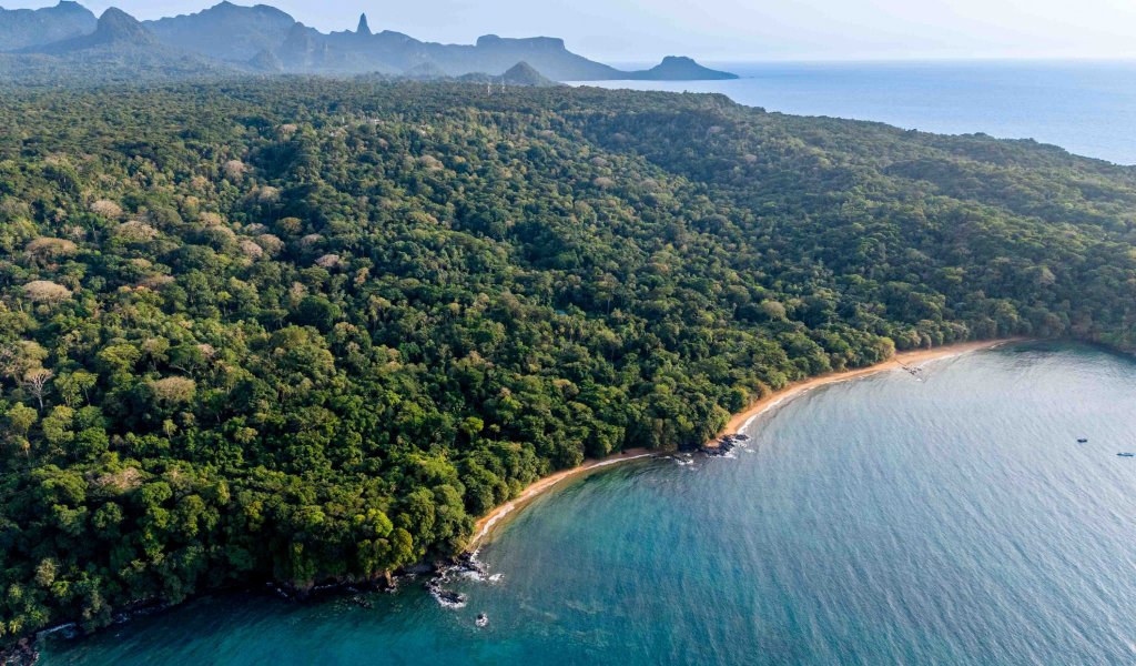 Aerial view of the Sundy Praia coastline with rainforest, beach and turquoise bay, Príncipe Island