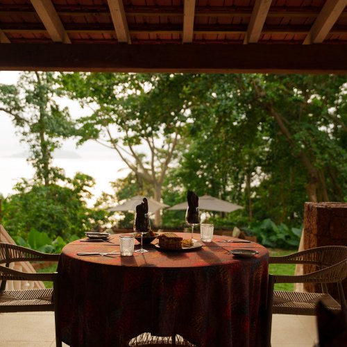 Mesa posta para o almoço no terraço coberto do Belo Monte com vista para a floresta e o oceano