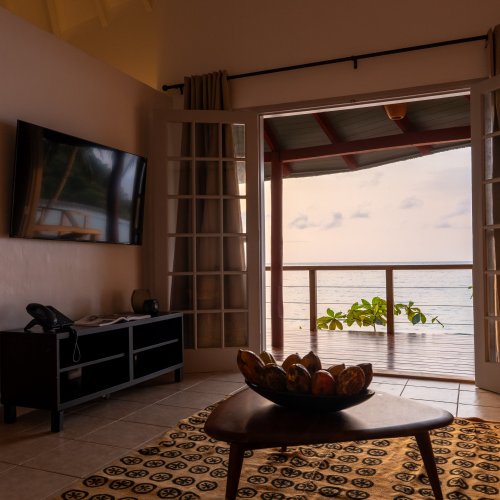 each bungalow with a four-poster bed at Bom Bom Beach Resort.
