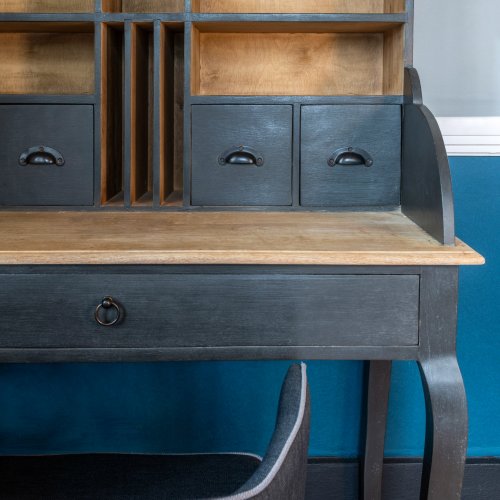 Close-up of a vintage wooden desk with drawers and compartments at Roça Sundy