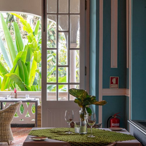 Charming room at Roça Sundy with a view of the lush garden