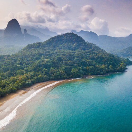 Aerial view of a secluded beach with lush forest on São Tomé Island