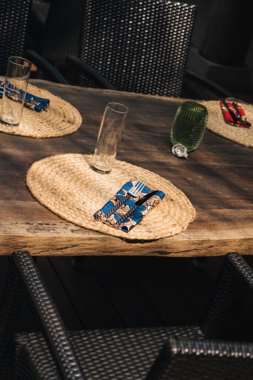 Table setting with woven placemats and batik napkins at Bom Bom Beach Club