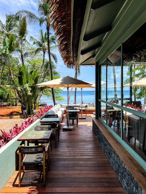Outdoor dining area with ocean view at Bom Bom Beach Resort.