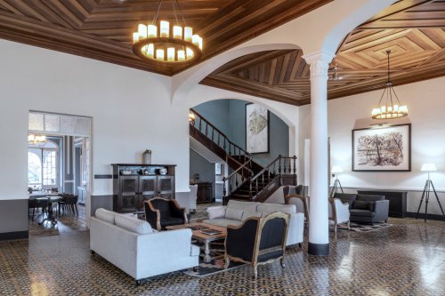 Receção e lobby espaçosos na Eclipse House na Roça Sundy com mobiliário elegante e teto de madeira