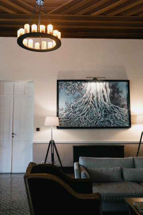 Elegant lobby corner at Eclipse House in Roça Sundy featuring a chandelier, artwork, and cozy seating