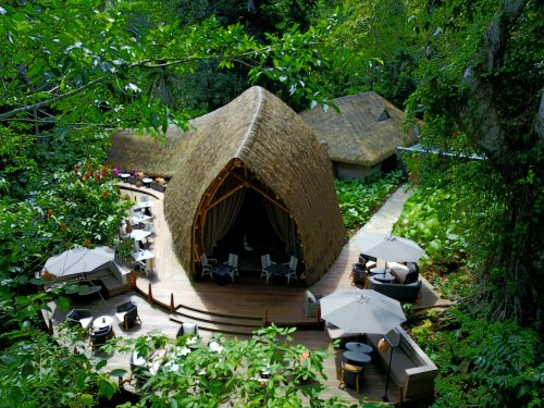 Top view of OKA Sundy Restaurant deck in the forest at Sundy Praia, shaded seating for open-air dining