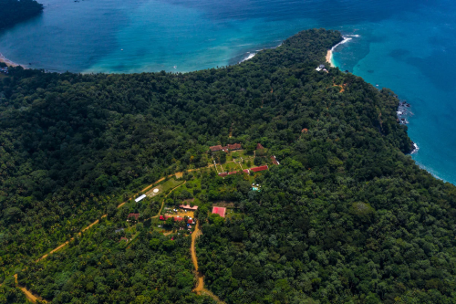 Aerial view of Belo Monte on Príncipe Island, plantation house nestled in rainforest between turquoise bays and beaches.