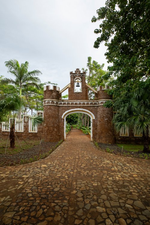 Historic fortified stone gateway with a bell tower at the entrance to Belo Monte on Príncipe Island