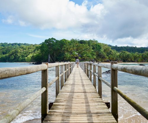 Jetty bridge with man walking to Bom Bom
