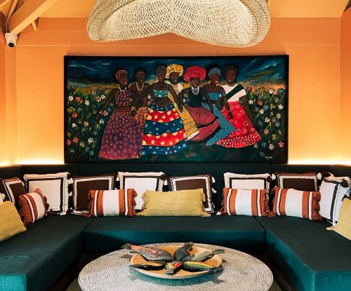 A vibrant living area with artwork and comfortable seating at Bom Bom Beach Resort.
