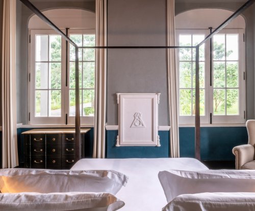 Bright suite at Eclipse House in Roça Sundy with a four-poster bed and garden view