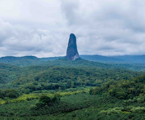 Vista panorâmica do Pico Cão Grande erguendo-se acima da densa floresta tropical, Ilha de São Tomé