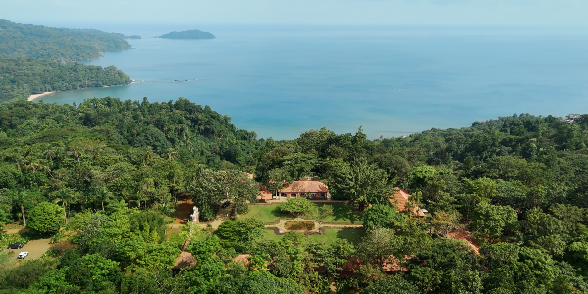 Aerial view of Roça Belo Monte's plantation estate set in rainforest above the ocean on Príncipe Island