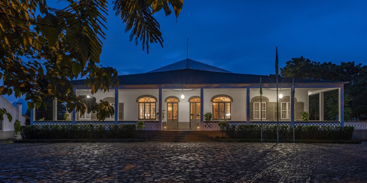 Exterior view of the illuminated Eclipse House at Roça Sundy at night