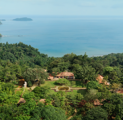 Aerial view of Roça Belo Monte's plantation estate set in rainforest above the ocean on Príncipe Island