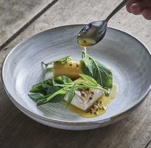 Fine dining dish presented on a table at OKA Sundy restaurant