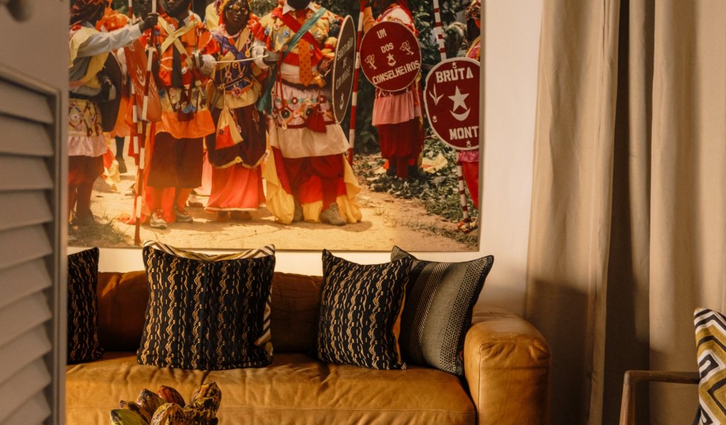  Living area with a couch and African art in a beach bungalow at Bom Bom Beach Resort