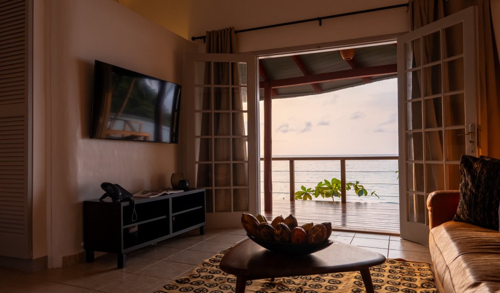 each bungalow with a four-poster bed at Bom Bom Beach Resort.