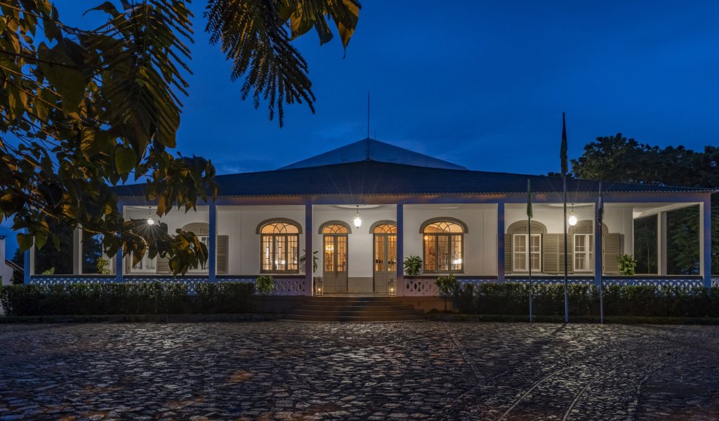 Exterior view of the illuminated Eclipse House at Roça Sundy at night