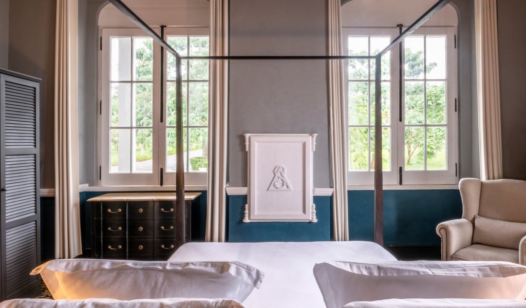 Bright suite at Eclipse House in Roça Sundy with a four-poster bed and garden view