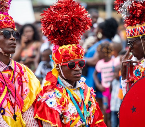 Three men in traditional costumes during a holiday on Príncipe Island
